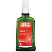 Green bottle of Weleda Pomegranate Regenerating Body Oil with white pump and red label, 100ml.