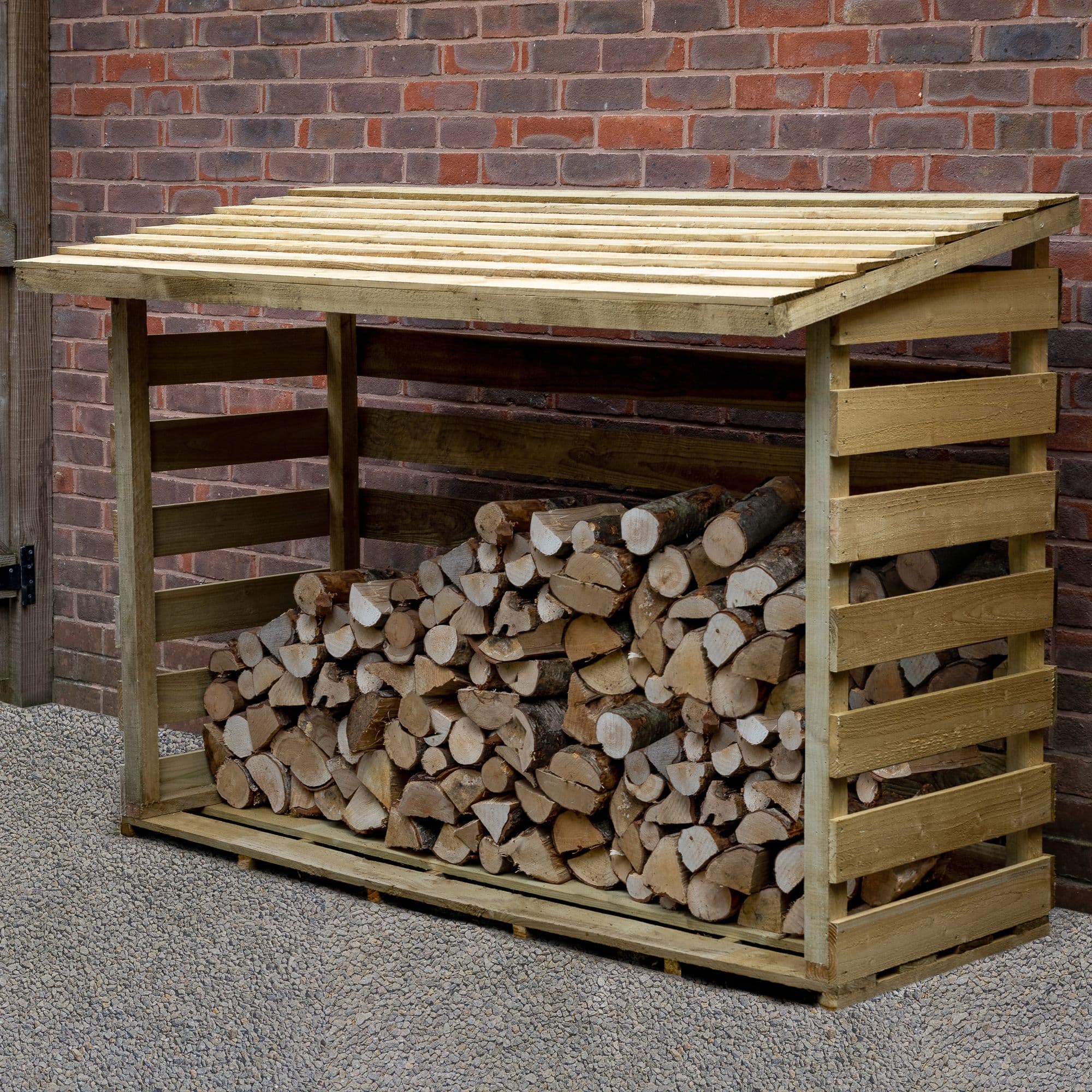Large wooden log store in natural finish, measuring 5'11" x 2'8", featuring a slatted roof and open sides, filled with neatly stacked logs against a brick wall background.