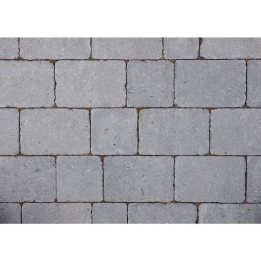 Gray rumbled concrete block paving with a textured surface, featuring rectangular blocks measuring 100mm x 134mm x 50mm, arranged in a staggered pattern.