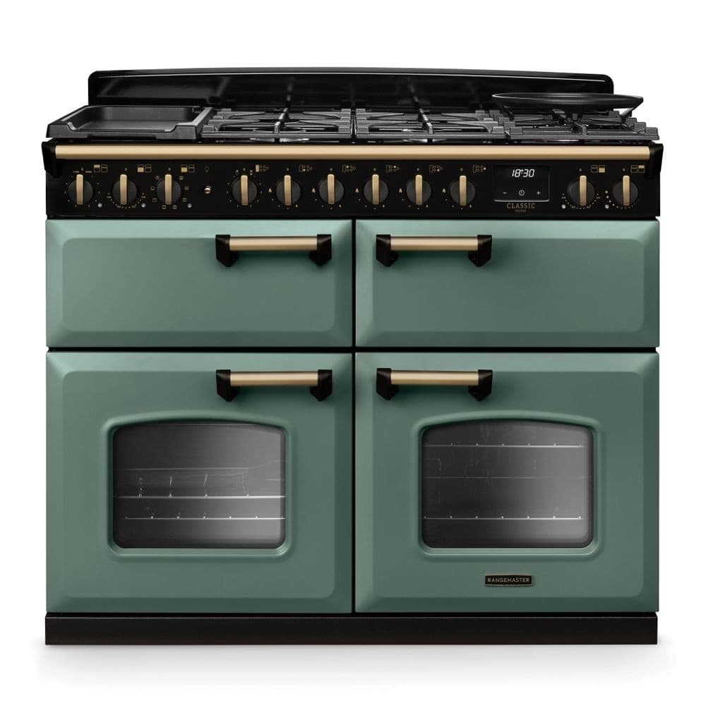 Classic Deluxe 110cm dual fuel range cooker in mineral green with antique brass accents, featuring four gas burners, two ovens with glass doors, and a stylish design.