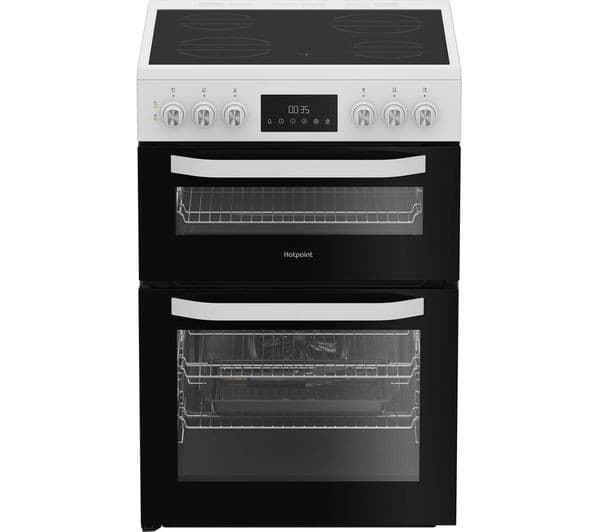 Hotpoint 60cm electric cooker in white with a black glass front, featuring four hob rings, digital display, and two glass oven doors.