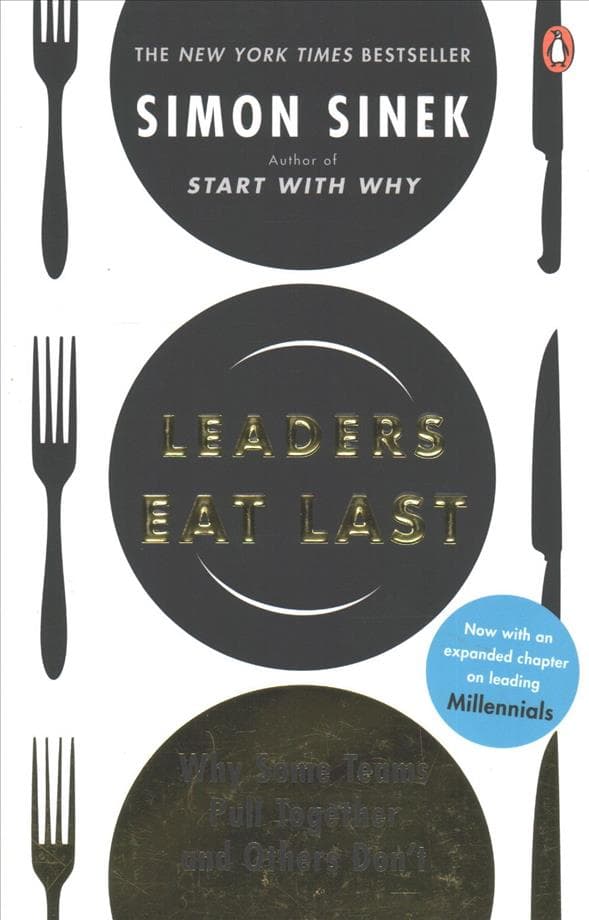 Non-fiction paperback "Leaders Eat Last" by Simon Sinek featuring a white cover with black and gold circular designs, and a blue sticker indicating an expanded chapter on Millennials.