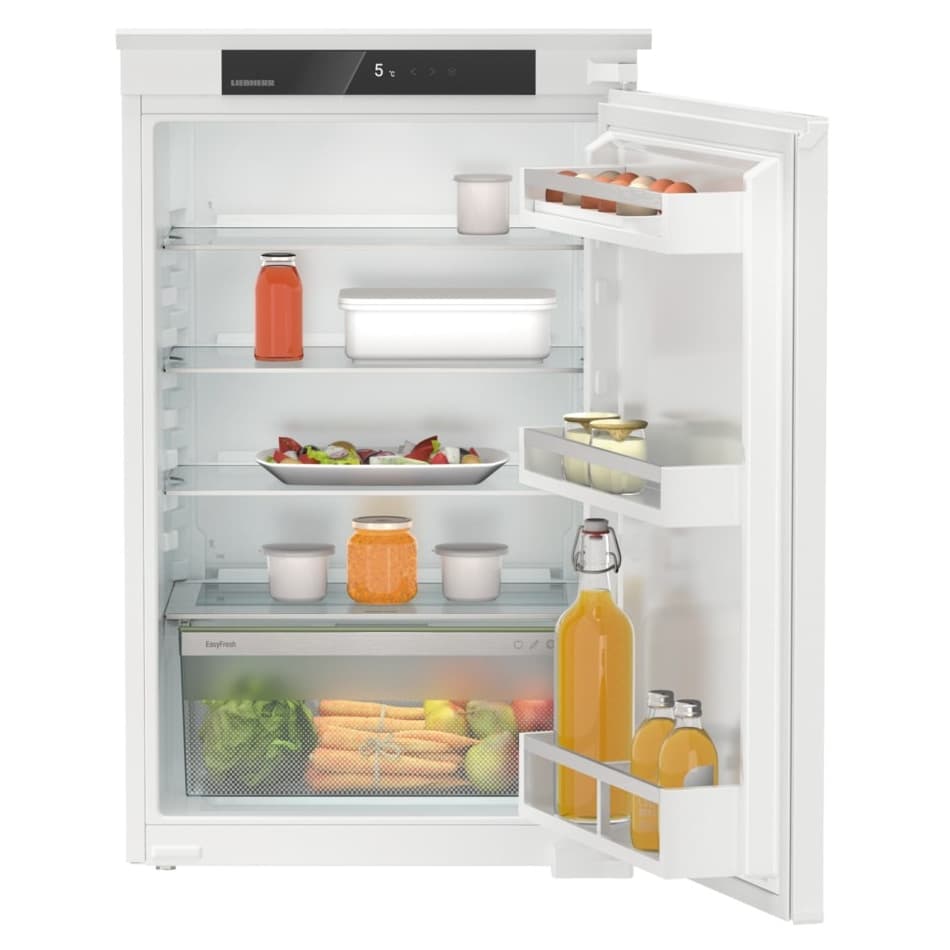 Liebherr Pure IRSE3900 built-in larder fridge in white, featuring a sliding door, multiple shelves, and clear storage bins filled with fruits, vegetables, and drinks.