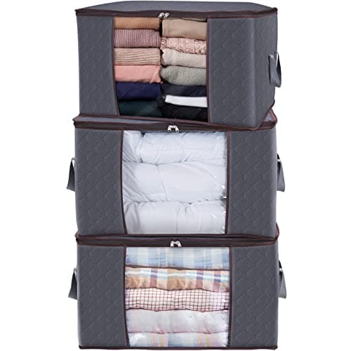 Gray fabric storage bags stacked, featuring transparent front panels, reinforced handles, and filled with neatly folded blankets and clothing, ideal for organizing bedding.