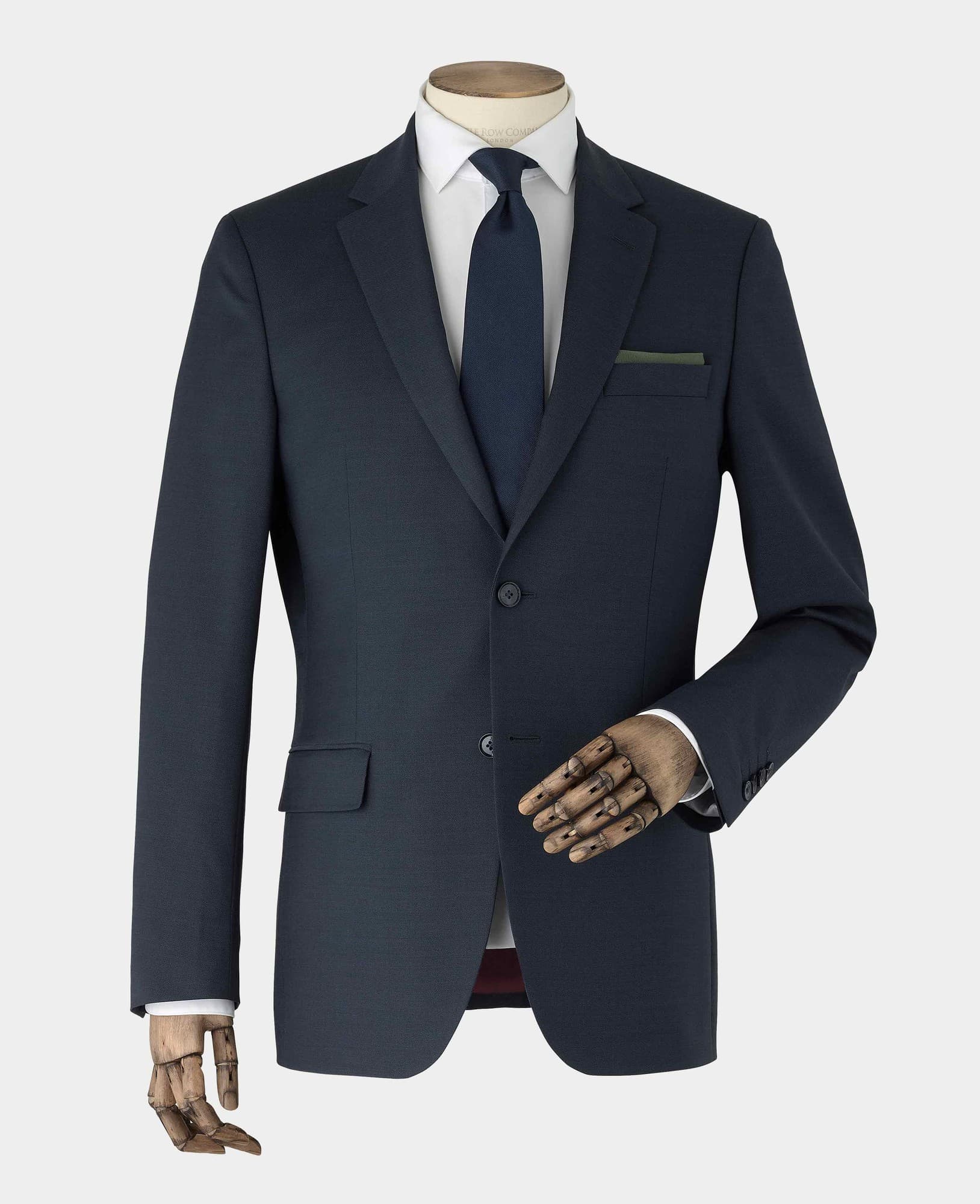 Men's dark navy wool blend suit jacket in size 48 X Long, featuring a notched lapel, single-button closure, and a chest pocket, displayed on a mannequin with a wooden hand.