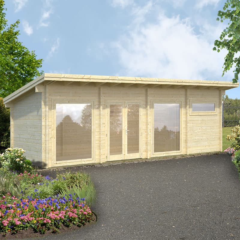 Light-colored wooden log cabin with large glass doors and windows, featuring a sloped roof, set amidst a landscaped garden with colorful flowers and greenery.