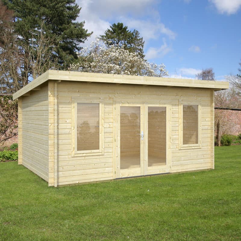 Light wooden log cabin garden room with a flat roof, double doors, and large windows, set on a grassy area with trees in the background.