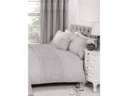 King-sized duvet set in silver, featuring a textured design, paired with matching pillowcases, elegantly displayed on a tufted headboard with a bedside table and lamp.