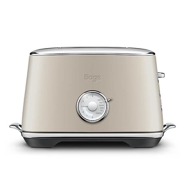 Sage Toast Select Luxe Toaster in Almond Nougat features a sleek, almond-colored body, chrome accents, a dial for browning control, and a compact design.