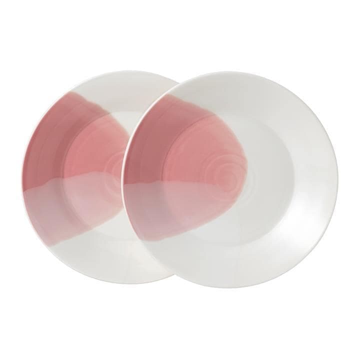 Two round ceramic tapas plates featuring a glossy white surface with a coral pink gradient along one edge, showcasing a modern and elegant design.