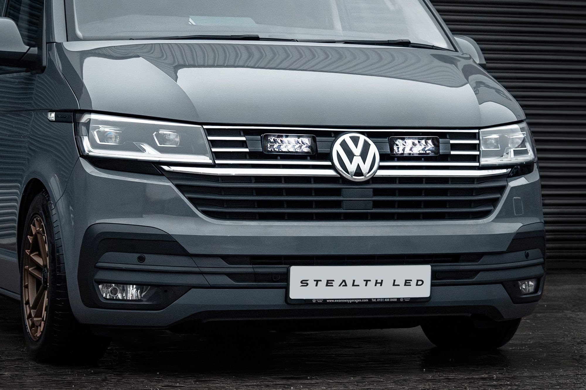 Stealth LED integration kit for VW Transporter T6.1, featuring twin 7" luminous LED lights, silver accents, and a sleek gray vehicle front with a prominent VW logo.
