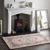 Shensi Pink Rug 75x150cm with floral pattern, ornate border, placed on wooden floor in elegant living room.