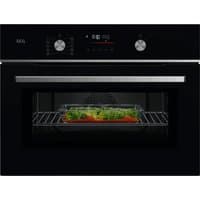 Black AEG CombiQuick oven-microwave with digital display, two knobs, and a glass door showing food inside.