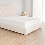 White Amazon Basics double fitted sheet on a bed, soft microfiber with 12-inch deep pocket, neatly fitted.