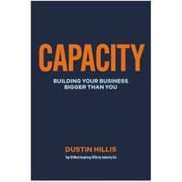 Navy blue book cover titled "CAPACITY" in orange, with subtitle "Building Your Business Bigger Than You" by Dustin Hillis.
