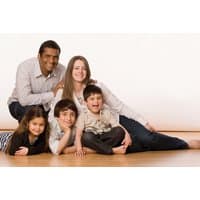 Family photoshoot package with framed photograph, featuring a smiling family of five on a wooden floor.