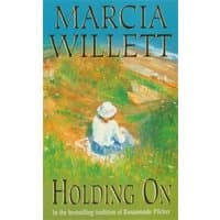 Book cover "Holding On" by Marcia Willett, features a woman in a hat sitting in a colorful meadow.
