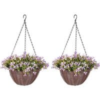 Hanging baskets with purple and white artificial flowers, green leaves, and metal chains.
