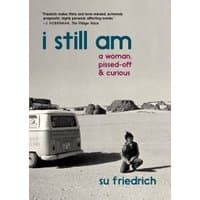Book titled "I Still Am A Woman, Pissed-Off & Curious" with black and white cover showing a person sitting by a van in a desert.