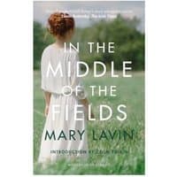 "In the Middle of the Fields" book by New Island Books, cover shows woman in white dress in grassy field.
