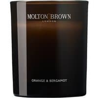 Black Molton Brown candle with "Orange & Bergamot" label, sleek glass container, and white text.