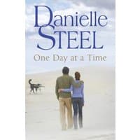 Book cover of "One Day at a Time" by Danielle Steel, featuring a couple walking on a beach with a dog.