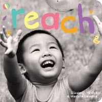 "Reach children's book cover with colorful title and smiling child reaching upwards in black and white background"