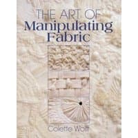 Book "The Art of Manipulating Fabric" with textured cream fabric cover and woven design elements.