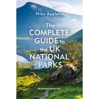 Book cover, "The Complete Guide to the UK National Parks," features a scenic landscape with mountains and a lake.
