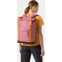 Pink Helly Hansen waterproof backpack 28L with orange straps and roll-top closure worn by person in orange shirt.