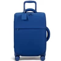 Blue Lipault Lost In Berlin suitcase with four wheels, top handle, and front zipper pocket.