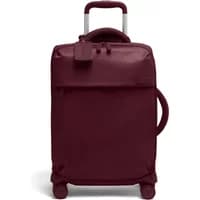 Burgundy Lipault Plume suitcase with telescopic handle, front pocket, and four spinner wheels.