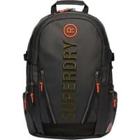 Black Superdry Tarp EMB Backpack with bold vertical logo, orange zipper pulls, and multiple compartments.