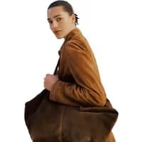 Brown suede tote bag by Stefanel, carried by a person wearing a matching suede jacket.