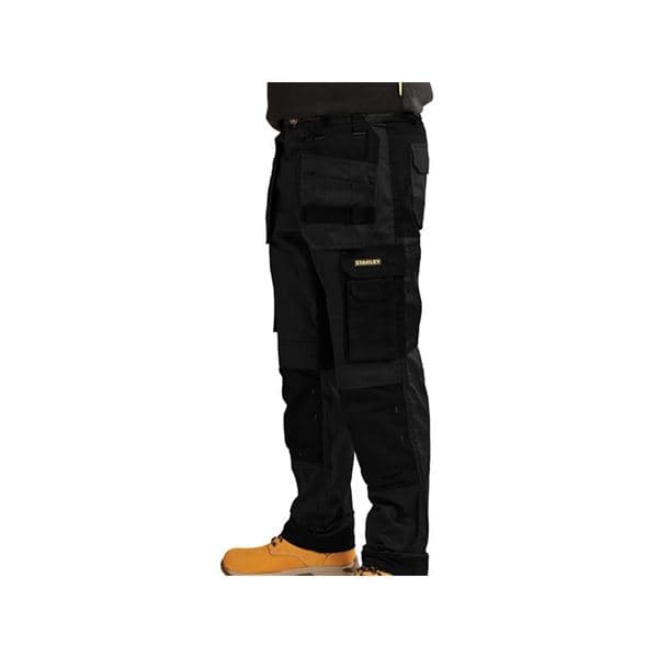 Black slim fit holster trousers by Stanley, featuring multiple pockets, reinforced knees, and a durable fabric, with a waist size of 32 inches and a leg length of 33 inches.
