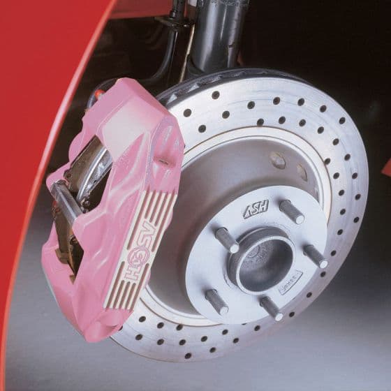 Bright pink E-Tech Engineering brake caliper mounted on a silver disc brake, featuring drilled holes and a polished finish, showcasing a sporty design.