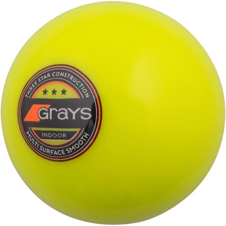 Bright yellow indoor hockey ball with a glossy finish, featuring a black and orange Grays logo and "Three Star Construction" label for multi-surface use.