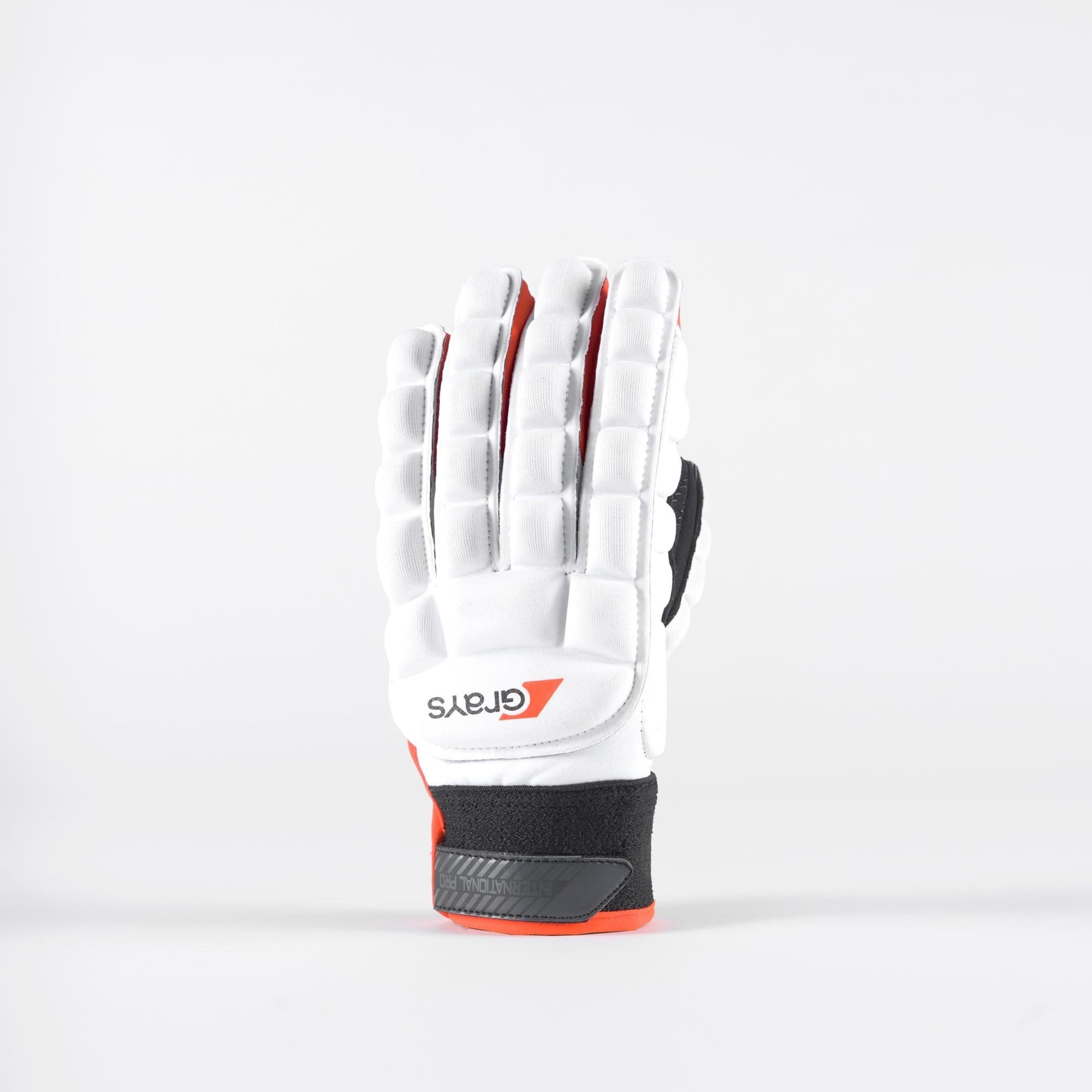 White Grays International Pro Gloves featuring padded protection, a textured grip, and vibrant red accents, designed for hockey performance.