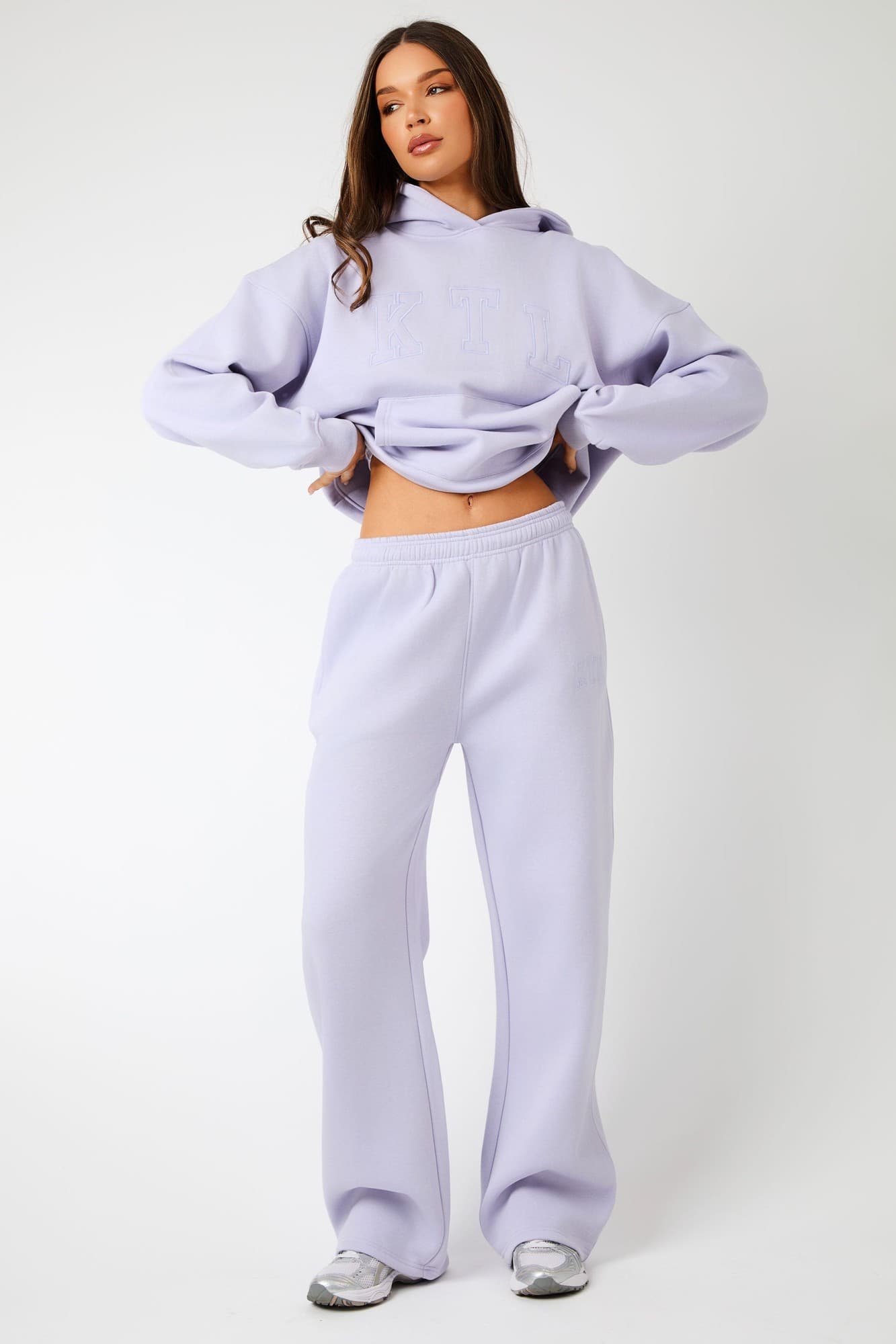 Wide leg joggers in iced lilac, made from soft material, featuring an elastic waistband and a relaxed fit, paired with a matching hoodie for a coordinated look.