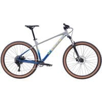 Grey and blue Marin Bobcat Trail 3 hardtail mountain bike, 27.5-inch wheels, black saddle, and brown tires.