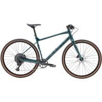 Teal Marin DSX 1 hybrid bike with flat handlebars, disc brakes, and brown-rimmed tires.