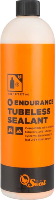 Orange Seal Endurance Sealant Refill in a 16oz bottle, featuring a bright orange label with black text, designed for tubeless systems, highlighting compatibility and longevity.