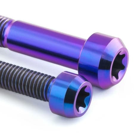 Purple titanium front brake caliper mounting bolts with a shiny finish, featuring hexagonal heads and threaded shafts, designed for durability and performance.