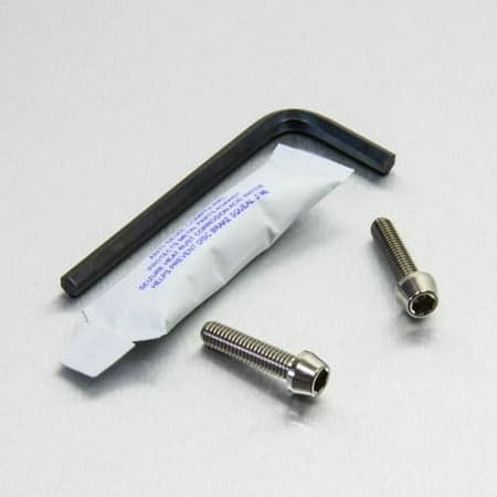Pro-Bolt Titanium Rear Brake Master Cylinder Bolt Kit in silver, featuring two silver titanium bolts, a black hex key, and a small packet of thread locker.