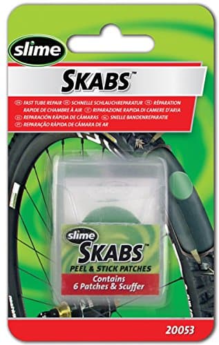 Pre-glued tire repair patches in a clear plastic case, featuring a green and white label, designed for quick and easy application on bicycle tires, with six patches included.