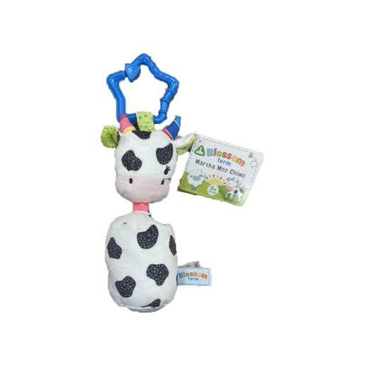 Soft plush cow toy with black spots, pink face, and a blue star-shaped clip; features a chime sound and a green tag for sensory play.