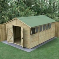 Wooden apex shed with double doors, green roof, and side windows, set on a concrete base in a garden.