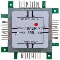Square electronic timer module with multiple pins, labeled "TIMER 555," featuring a red LED indicator.