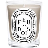 Diptyque Feu de Bois candle in clear glass jar with black and white label, 190g woody scent.