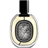 Clear glass bottle of Diptyque Vetyverio Eau de Parfum, oval shape, black cap, ornate black and white label.